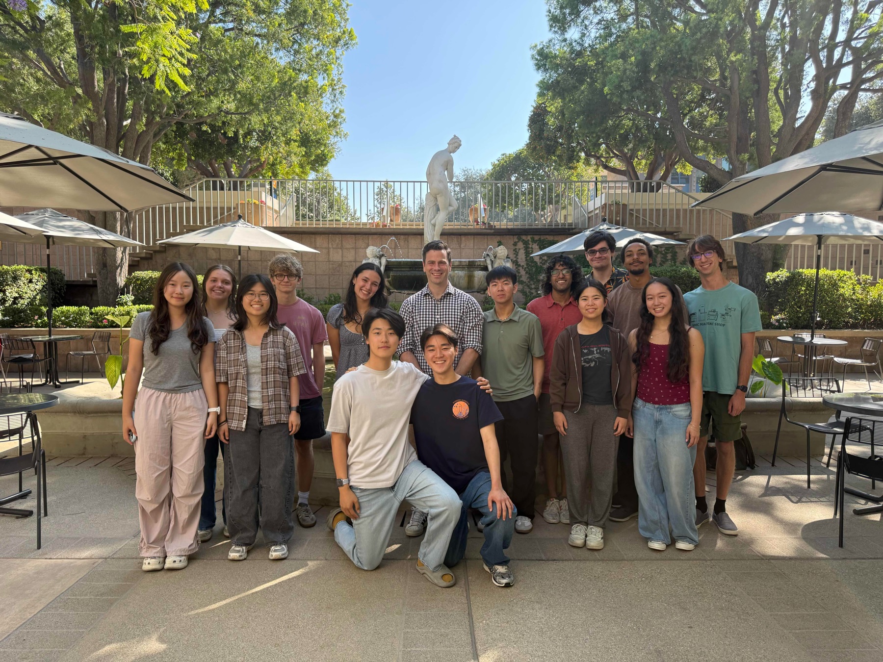 PoSM Lab group posing in front of a courtyard fountain